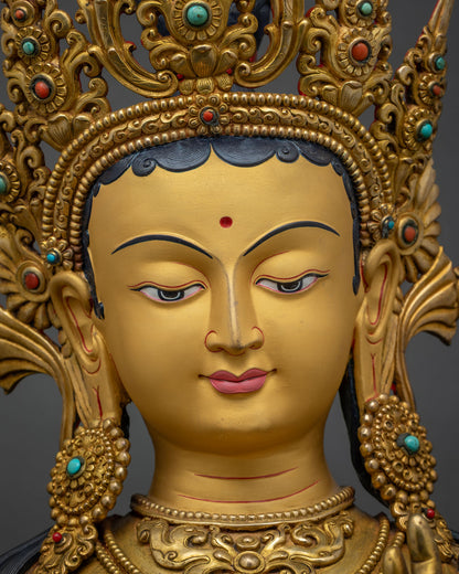 Green Tara Statue face close up, serene expression with gold gilded crown detail