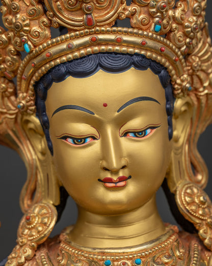 Green Tara Statue face close up, serene gold painted Buddhist deity detail