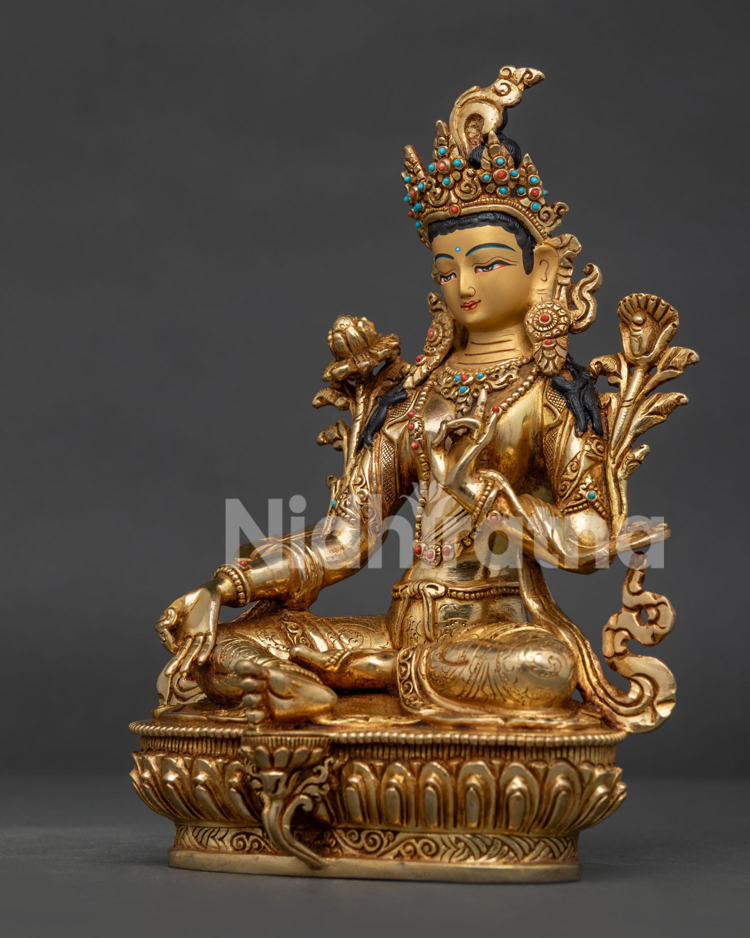 Green Tara statue face showing Newari craftsmanship and Himalayan Buddhist art.
