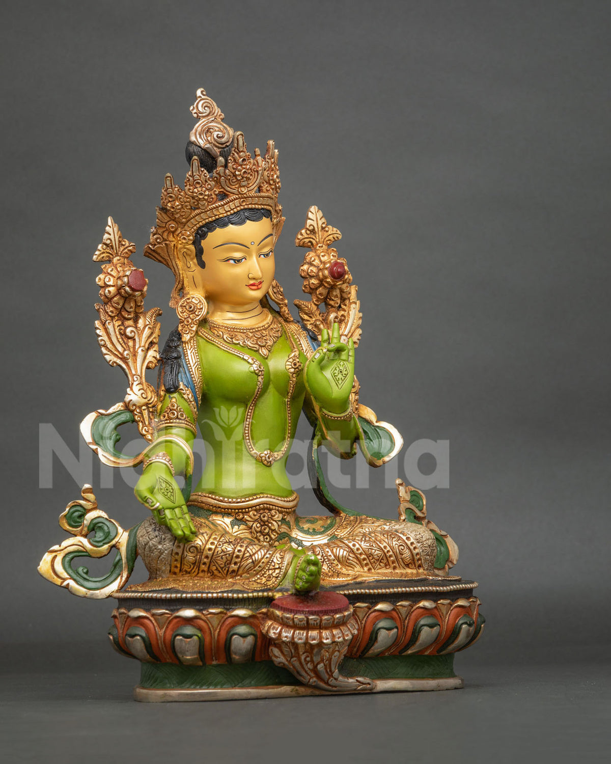 Green Tara statue with five jewel crown layered necklaces and gold gilded details.