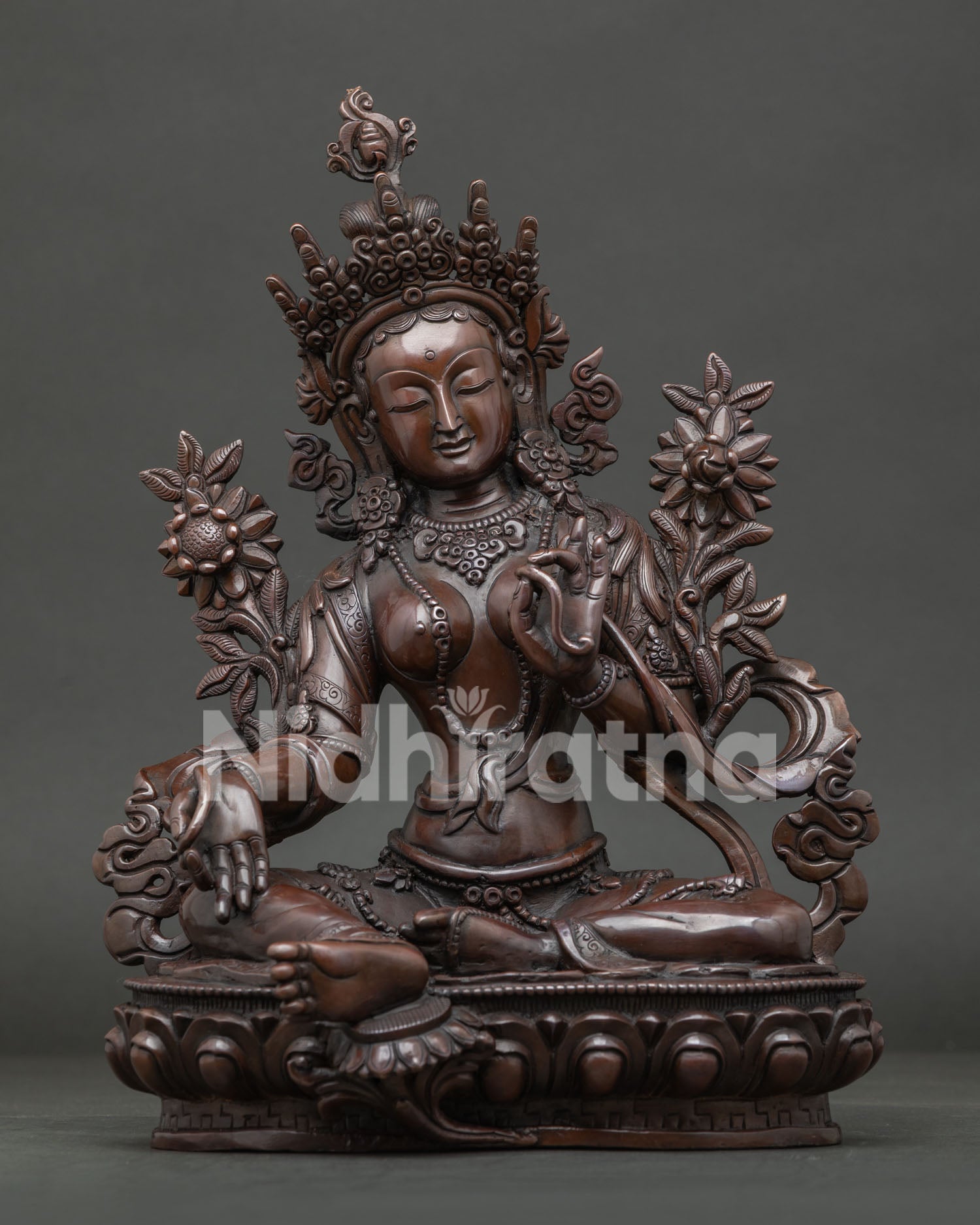 Green Tara Statue from Nepal with oxidized copper finish and hand carved lotus pedestal.