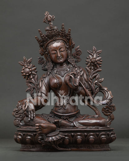 Green Tara Statue from Nepal with oxidized copper finish and hand carved lotus pedestal.