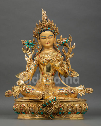 Green Tara statue front view with gold gilded copper body, turquoise and coral stone details, handcrafted Buddhist deity from Nepal.