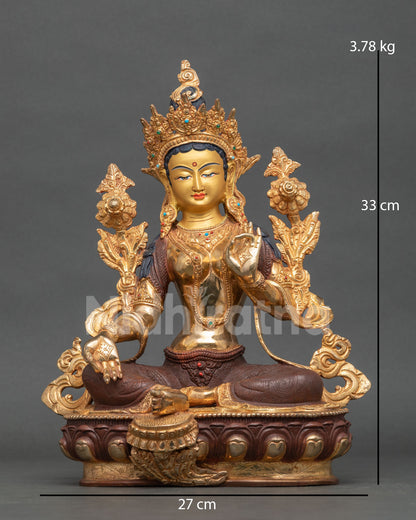 Green Tara statue front view half oxidized gold fire gilded Patan Nepal.