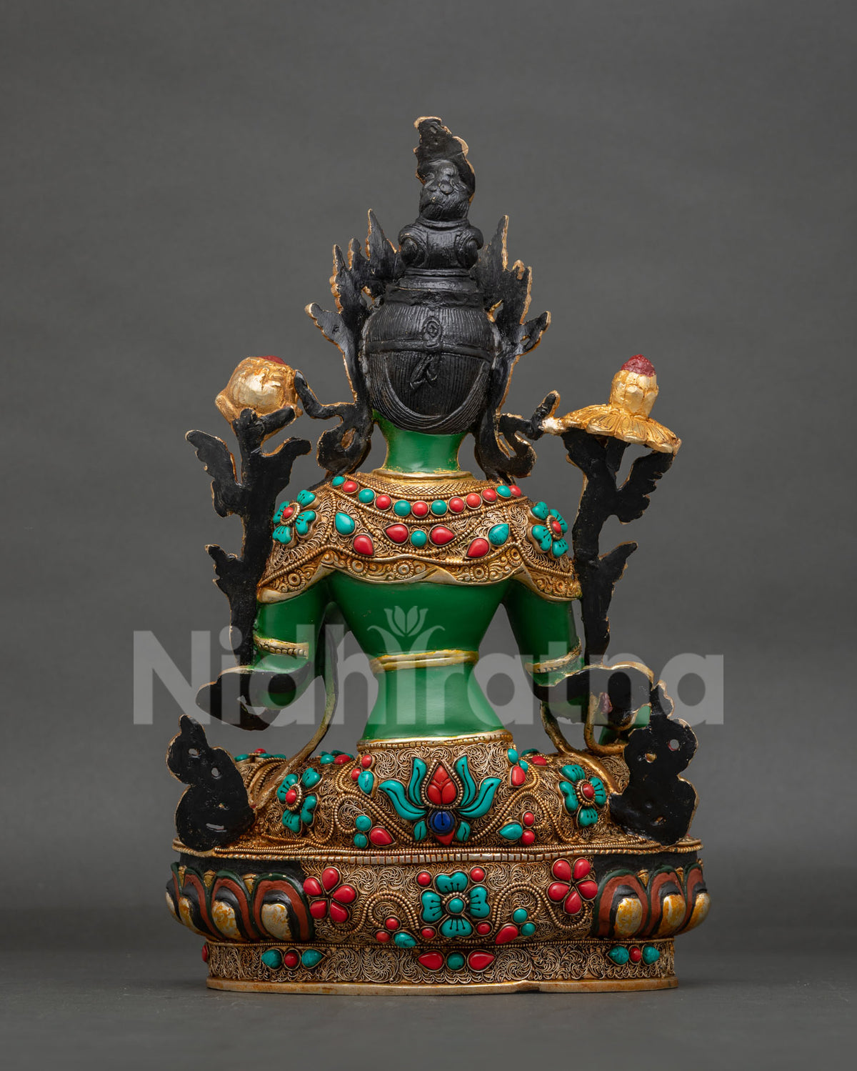 Green Tara statue seated on a hand carved lotus pedestal.