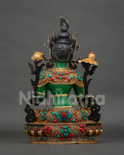 Green Tara statue seated on a hand carved lotus pedestal.