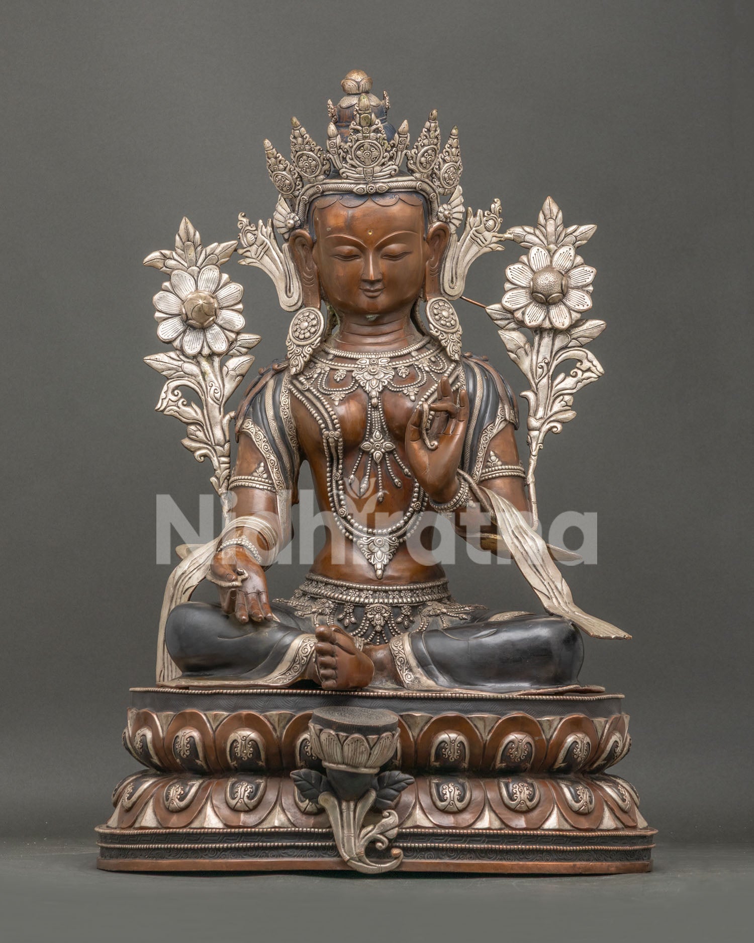 Green Tara Statue handcrafted in oxidized copper with silver details seated on a lotus throne