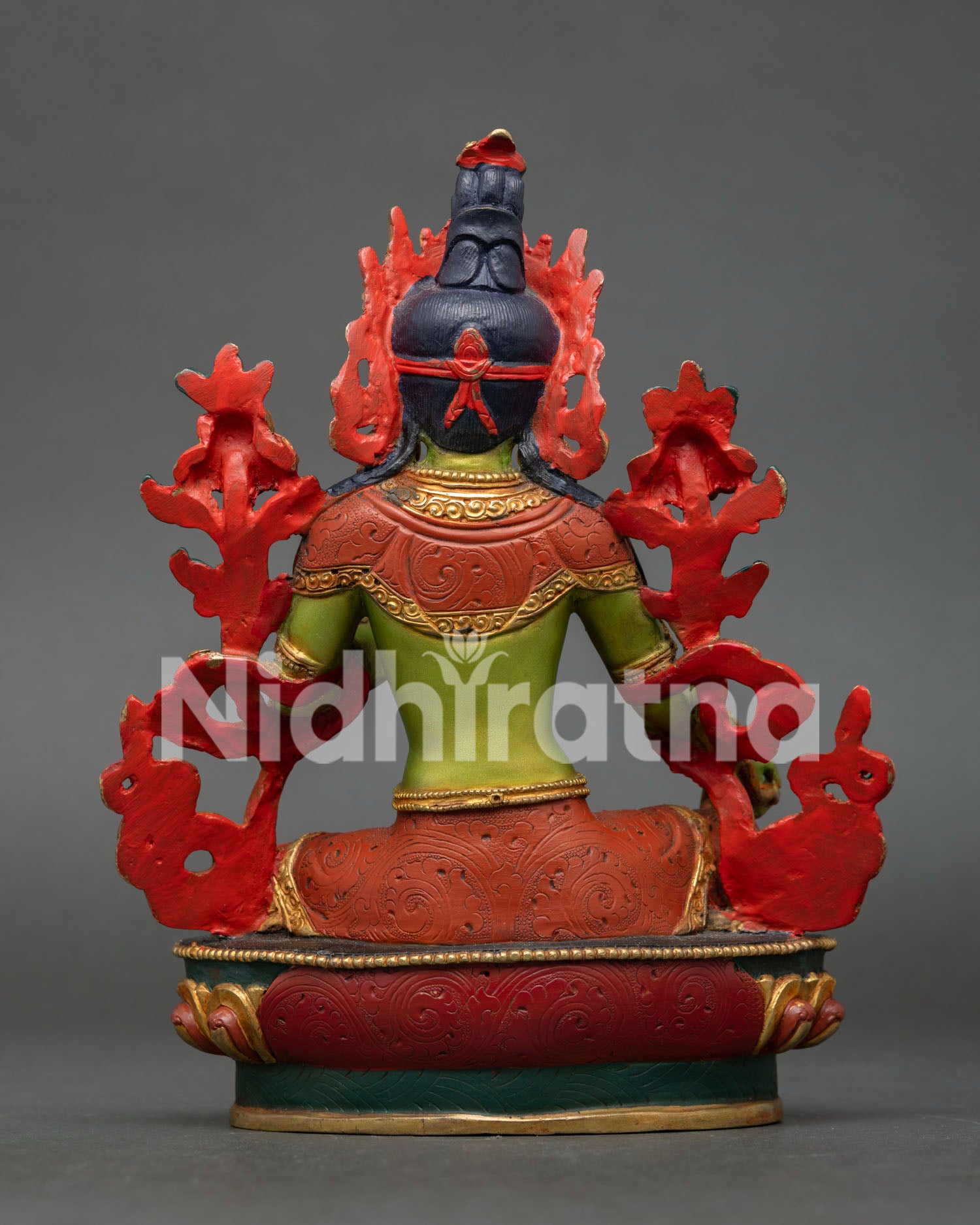 Green Tara statue highlighting intricate copper workmanship, vibrant acrylic colors, and gold gilded finish by skilled Nepalese artisans.