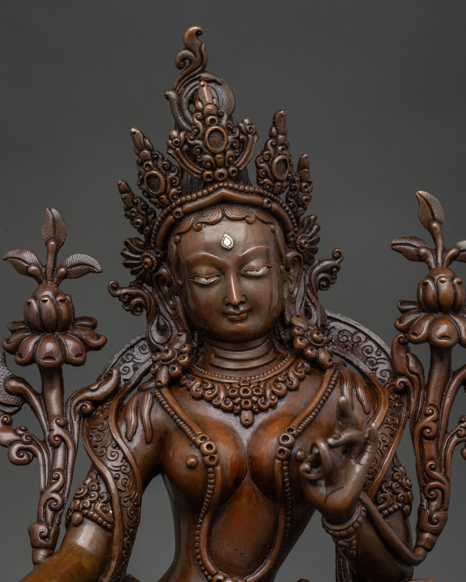 Green Tara statue in lalitasana on double lotus pedestal with silver urna.