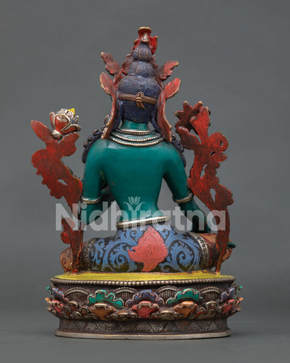 Green Tara statue in Lalitasana posture holding a blue lotus flower with sacred symbolic details.