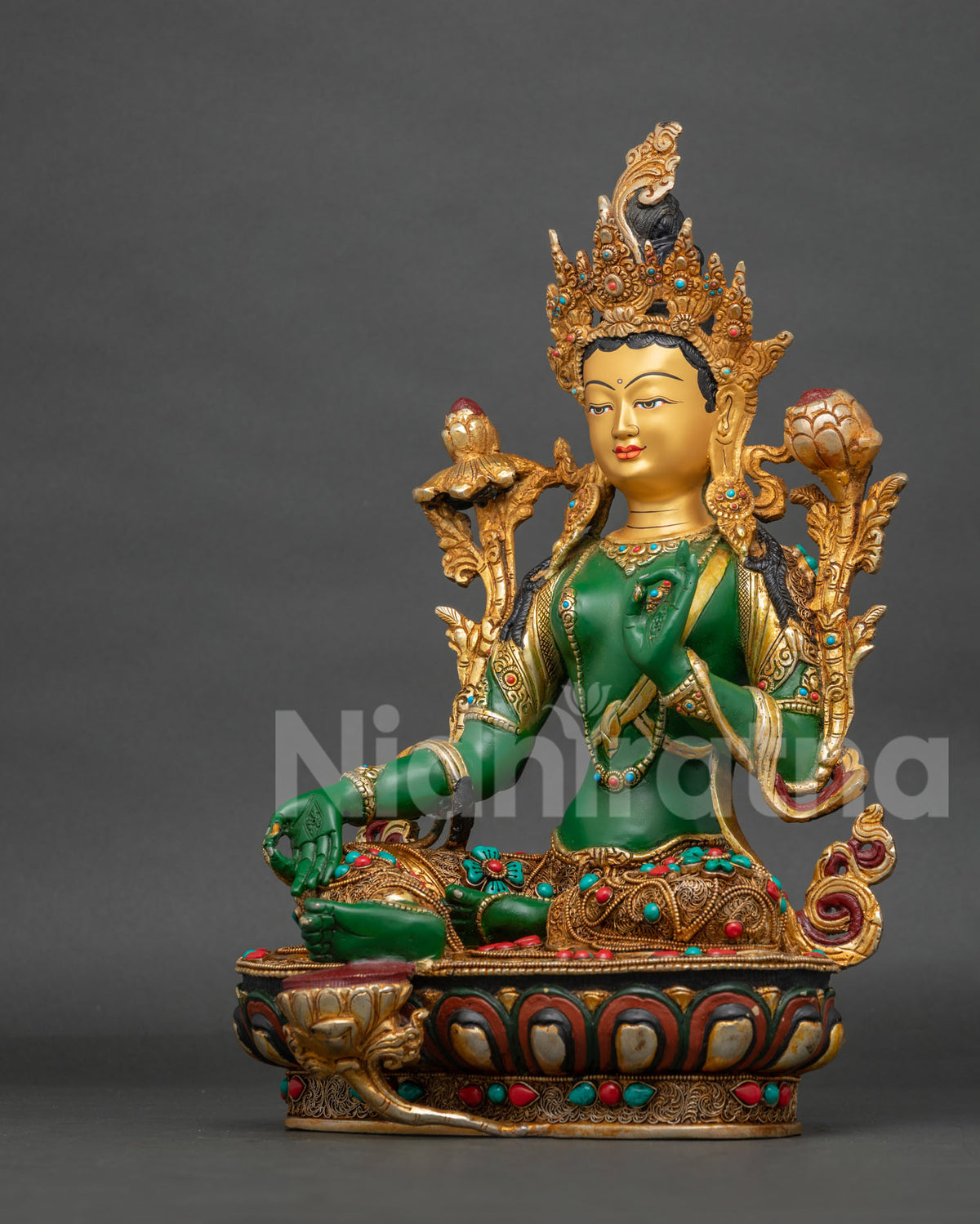 Green Tara statue with intricate silk garment filigree artwork and gold finish.