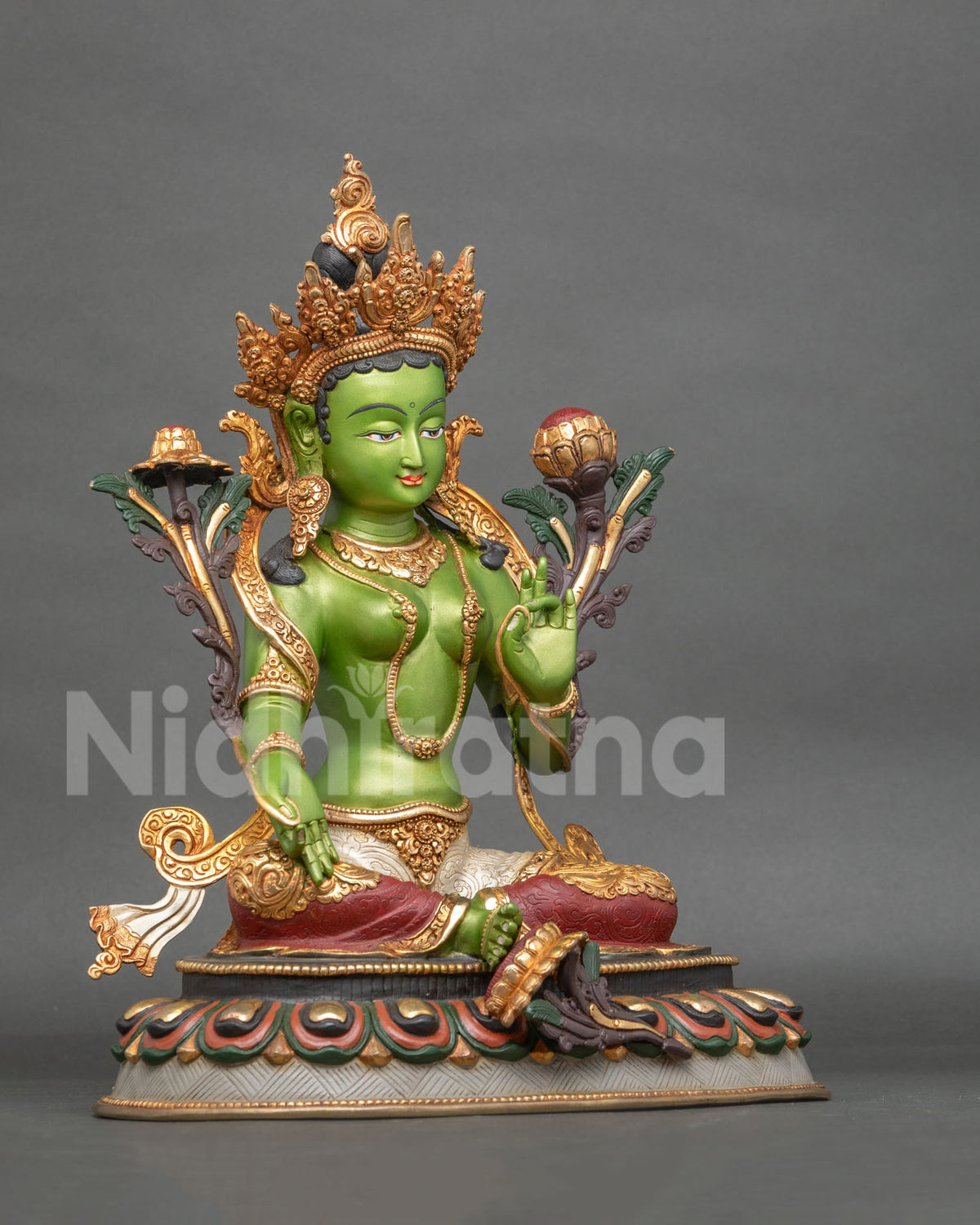 Green Tara statue in Lalitasana posture with lotus seat and extended right foot.