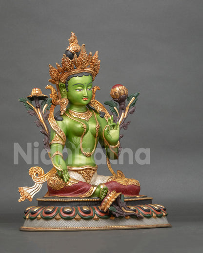 Green Tara statue in Lalitasana posture with lotus seat and extended right foot.