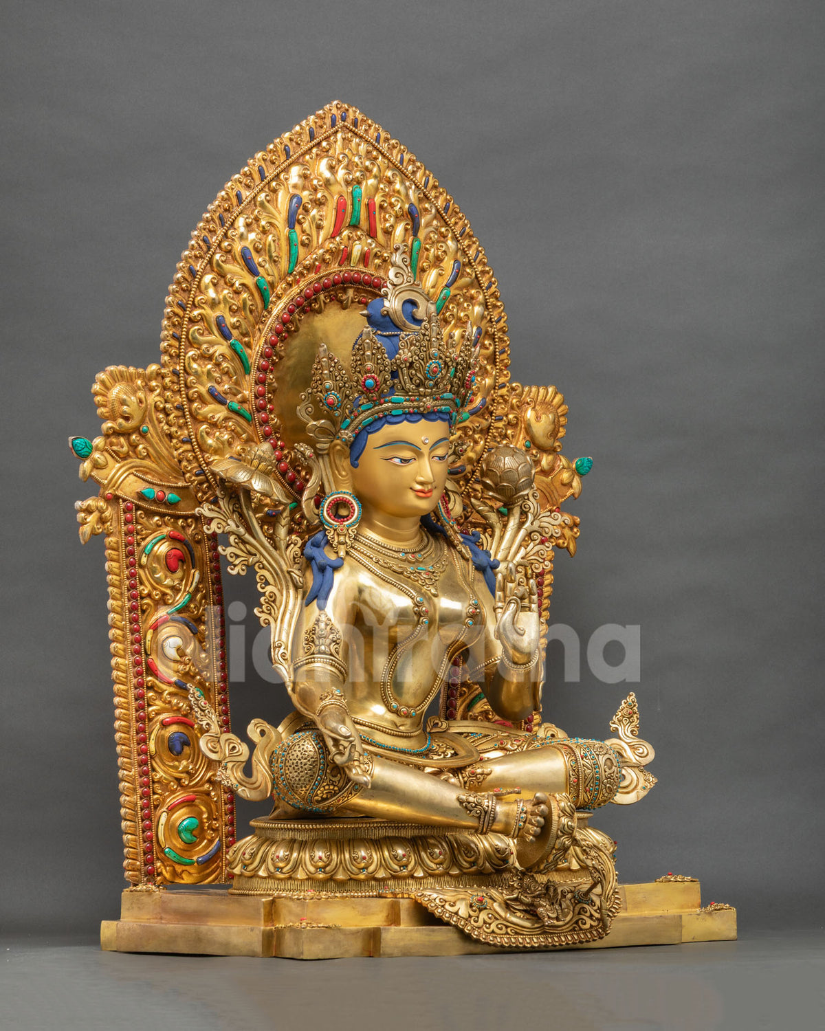 Green Tara statue left angle view with floral halo and lotus pedestal, handcrafted Buddhist sculpture