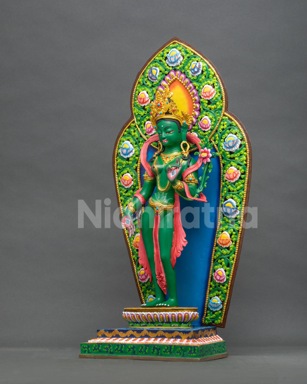 Green Tara statue left side view with floral scrolling halo and hand-painted lotus blossoms