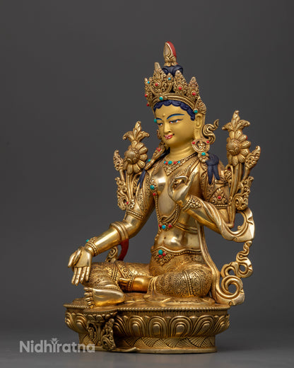 Green Tara statue left view Abhaya Mudra lotus pedestal floral motif silk garment.