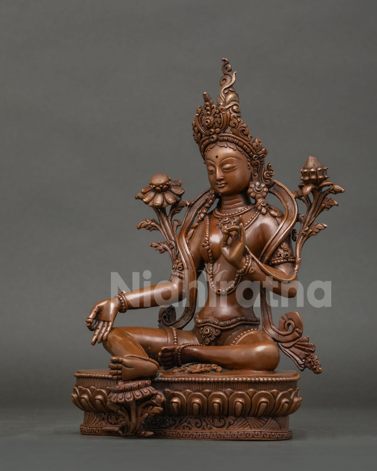 Green Tara Statue oxidized copper, left side view showing utpala lotus and vitarka mudra