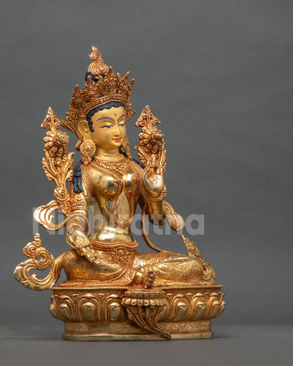 Green Tara Statue right side view Lalitasana utpala flowers gold gilded copper.