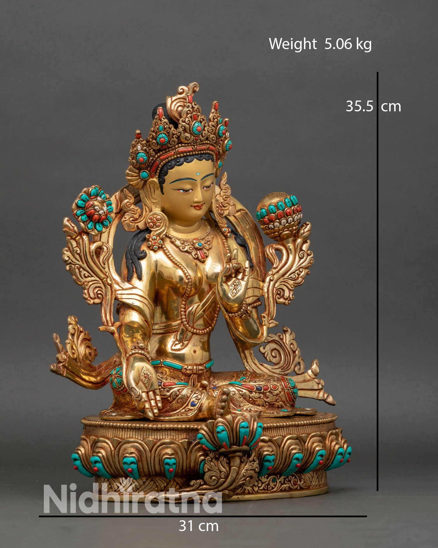 Right side view of Green Tara statue in royal ease posture holding utpala flower