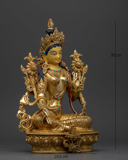 Green Tara statue right view Varada Mudra utpala flower semi precious stones gold fire gilded.