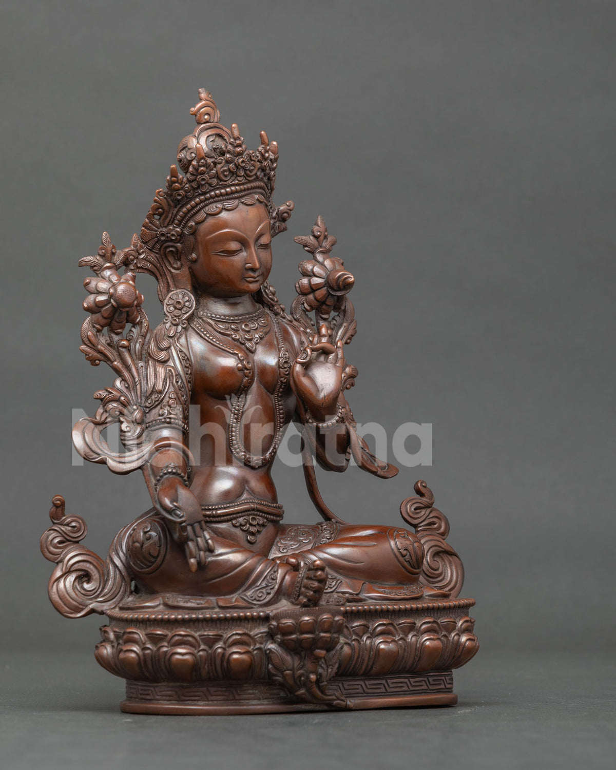 Green Tara statue seated in lalitasana on handcarved lotus pedestal.