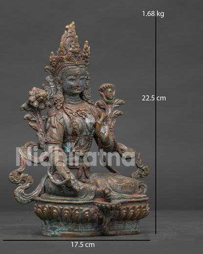Green Tara statue seated in lalitasana posture on lotus pedestal with extended foot.