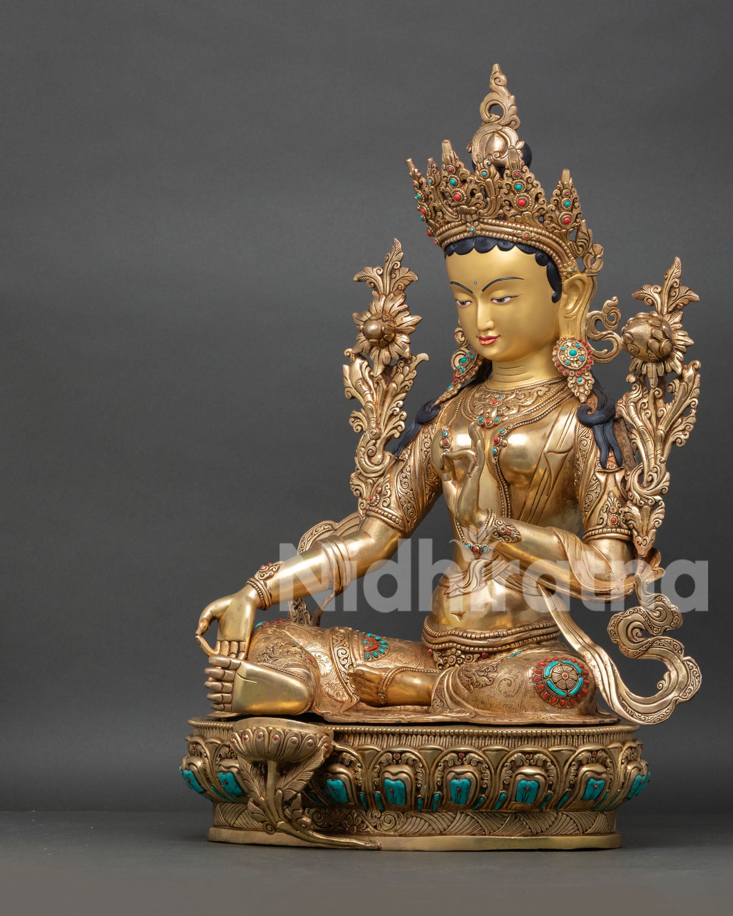 Green Tara Statue seated in Lalitasana posture with Utpala flower and sacred Buddhist symbolism.