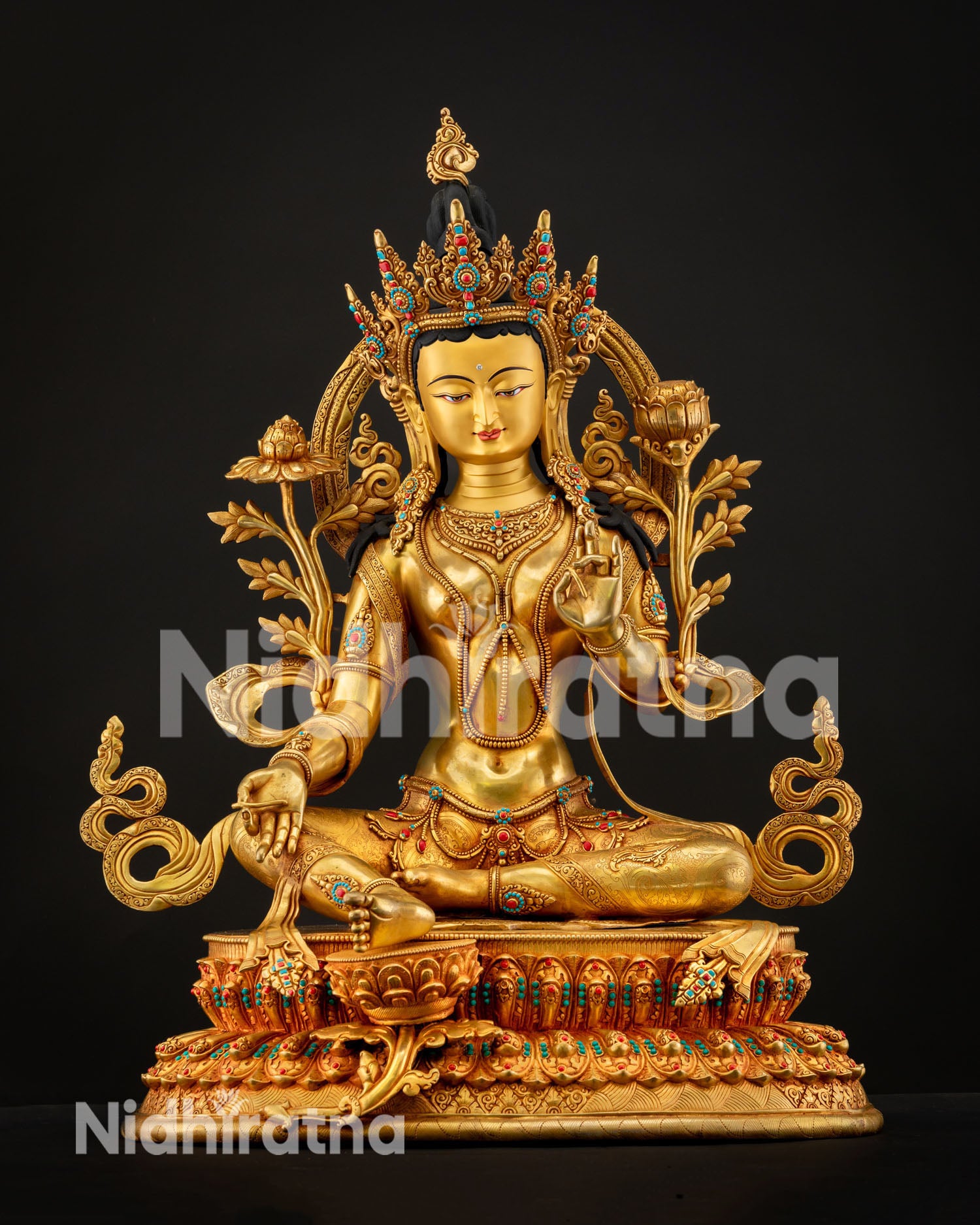 Green Tara statue seated on lotus throne symbolizing compassion protection and enlightened action in Buddhist tradition