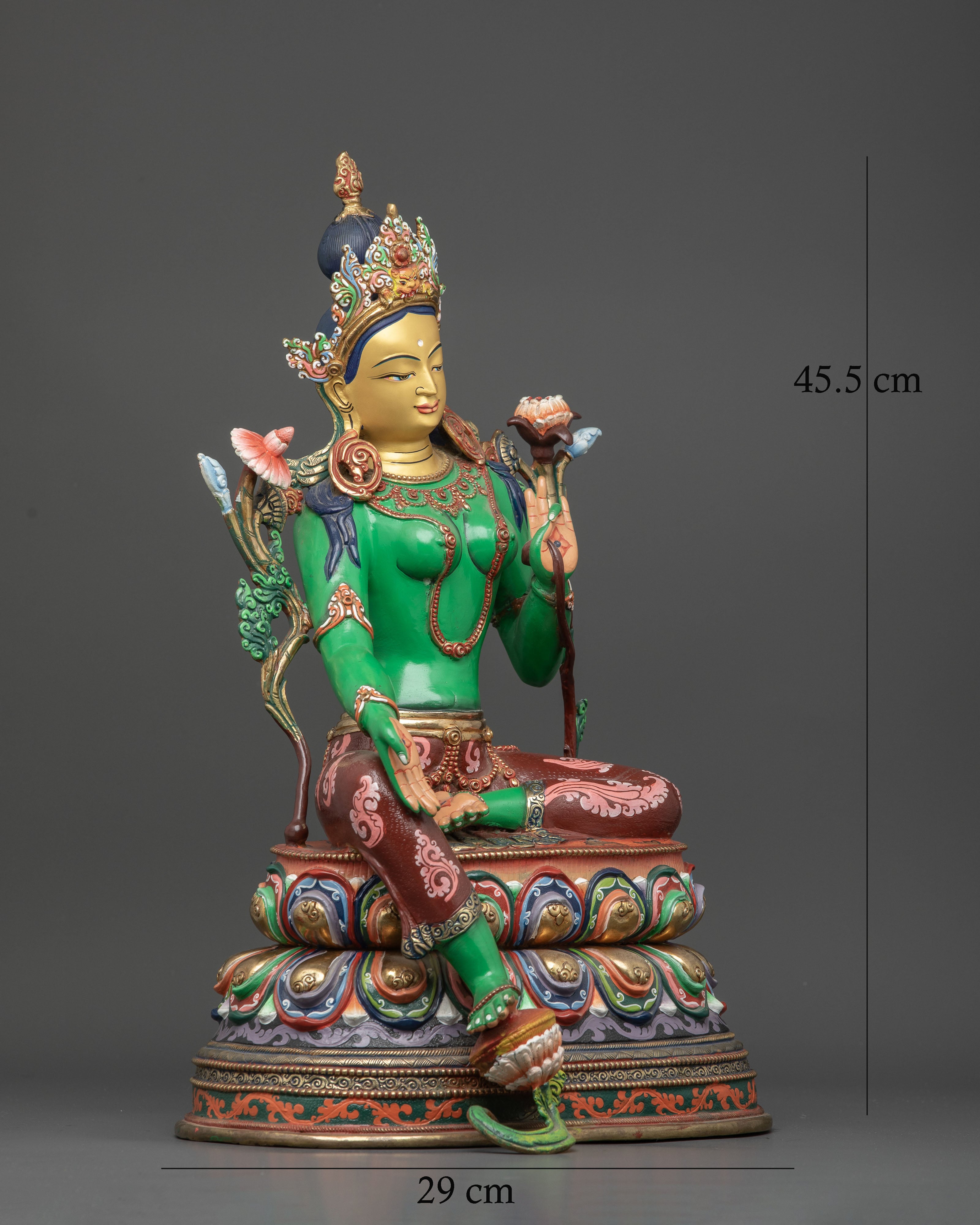 Green Tara statue seated on multicolored double lotus pedestal with Varada mudra.