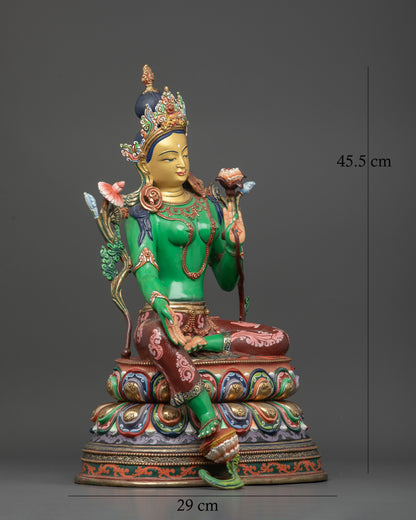 Green Tara statue seated on multicolored double lotus pedestal with Varada mudra.