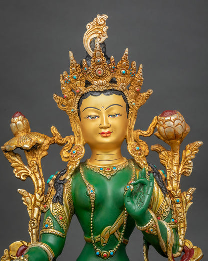 Green Tara statue adorned with semi precious stones and 24K gold painted details.
