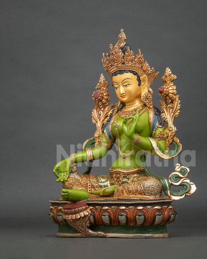 Green Tara statue adorned with semi precious stones and a 24K gold painted face.