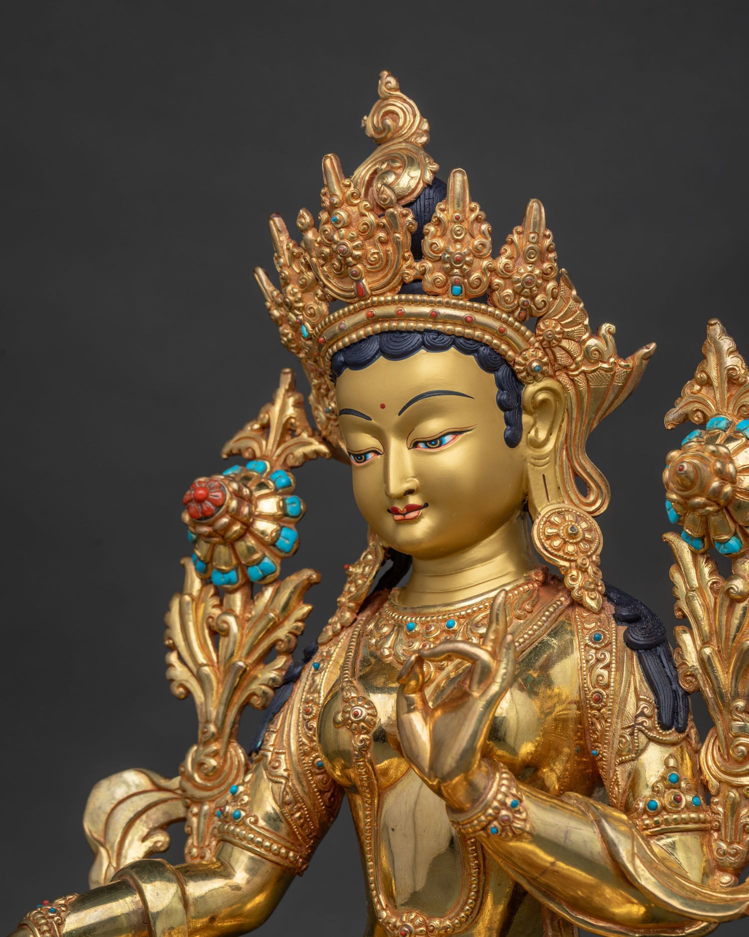 Green Tara Statue side close up, intricate gold gilded copper carving detai