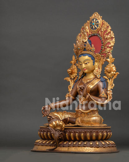 Green tara statue side view with intricate halo, crown and traditional nepalese craftsmanship