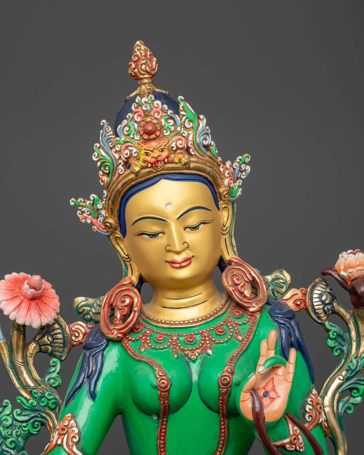 Green Tara statue with 24K gold painted face in graceful Lalitasana pose.