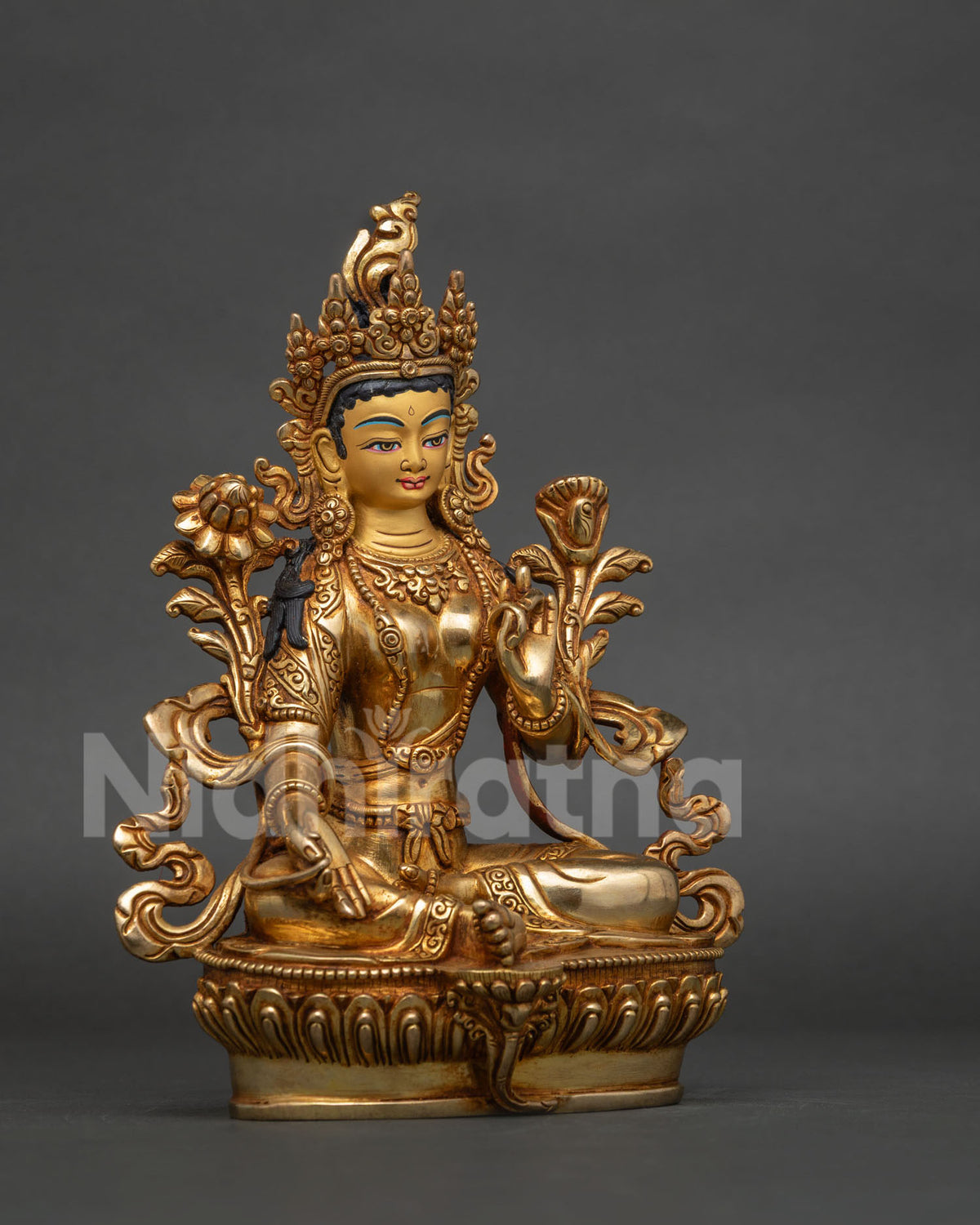 Green tara statue with hand-carved silk garment layered necklaces and five-jewel crown.