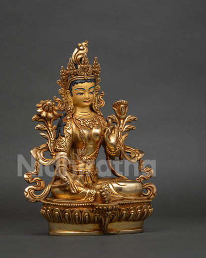 Green tara statue with hand-carved silk garment layered necklaces and five-jewel crown.
