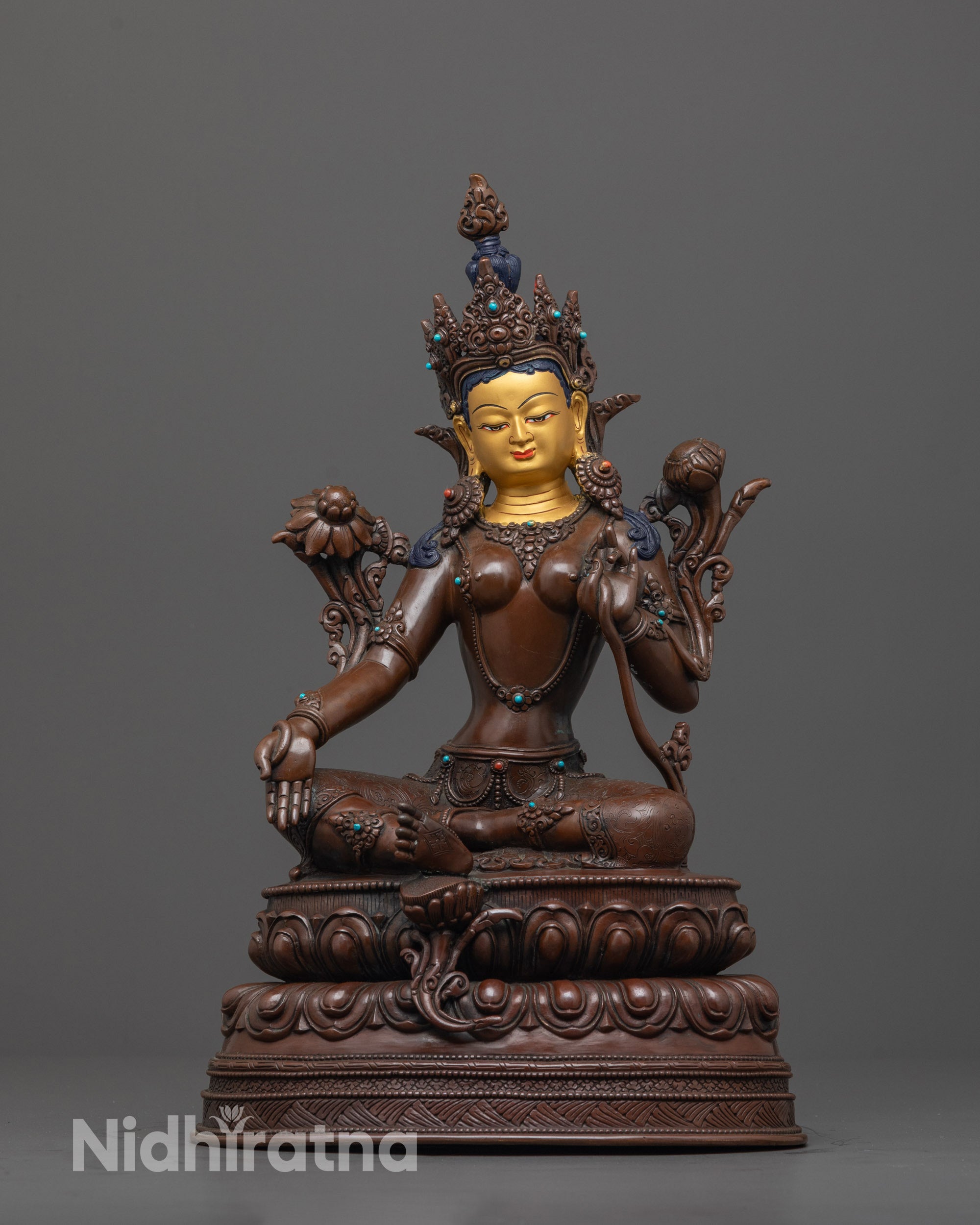 green tara statue front view with gold-gilded face and oxidized body on lotus base