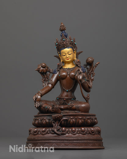 green tara statue front view with gold-gilded face and oxidized body on lotus base
