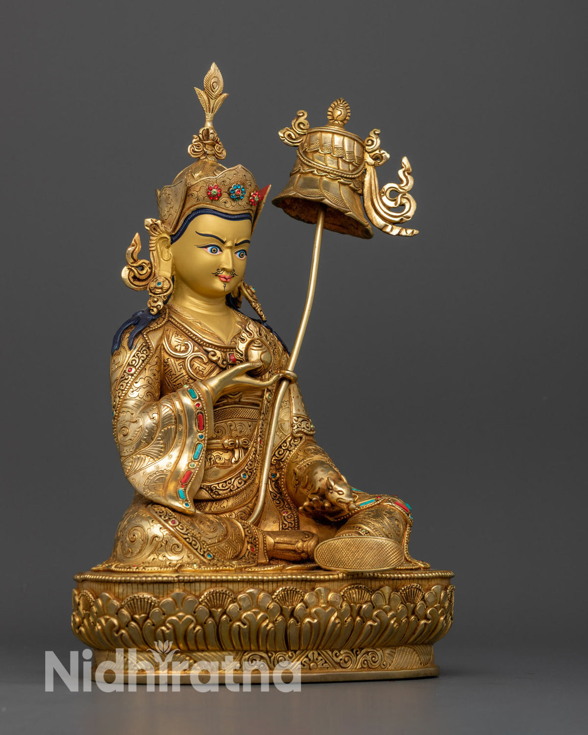 Guru Orgyen Norlha seated on lotus throne holding wish fulfilling jewel and treasure bearing mongoose