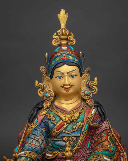 Guru padmasambhava copper statue with 24k gold painted face red lotus hat and vulture feather.
