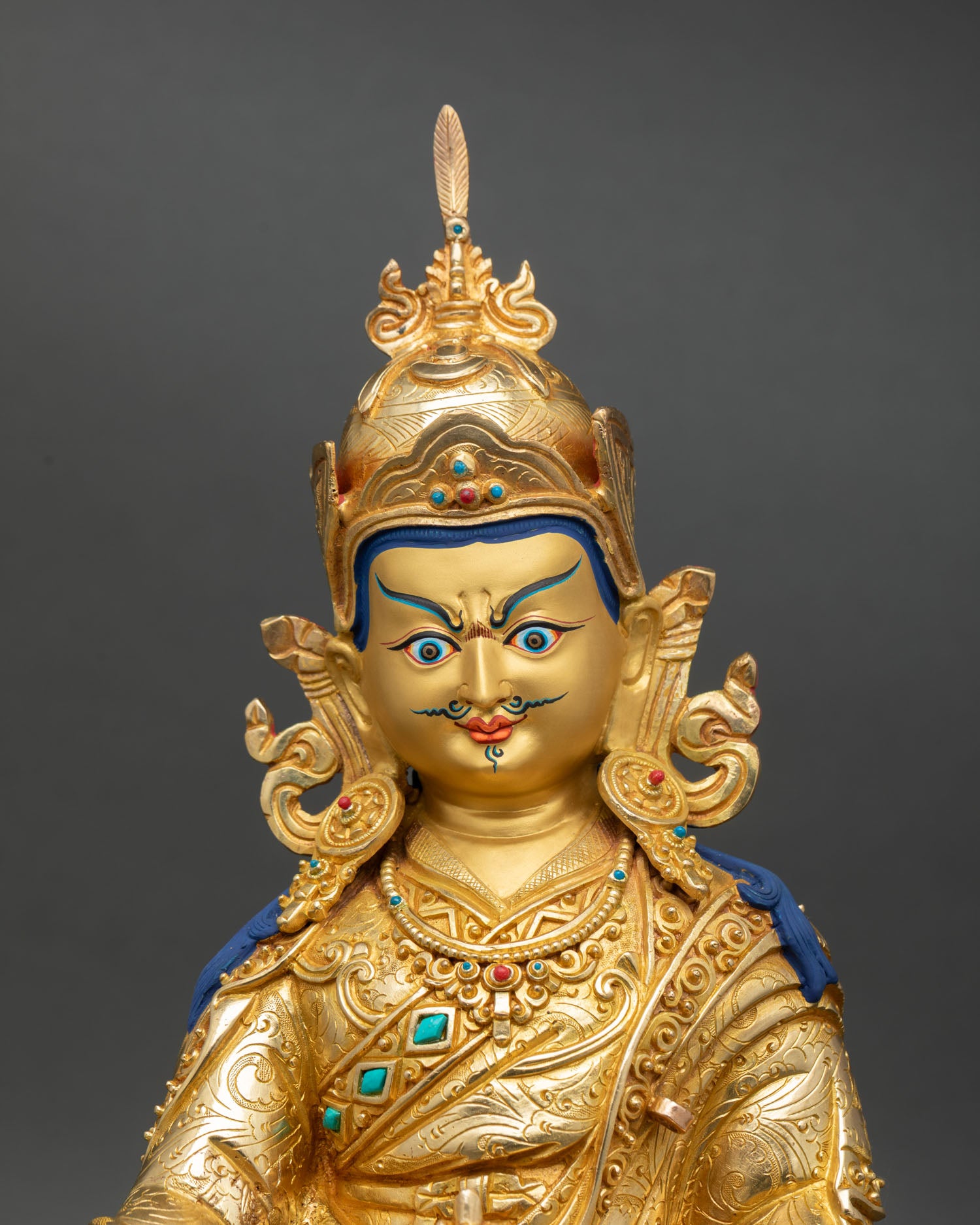 Guru Padmasambhava statue close up gold painted face detail copper craft nepal