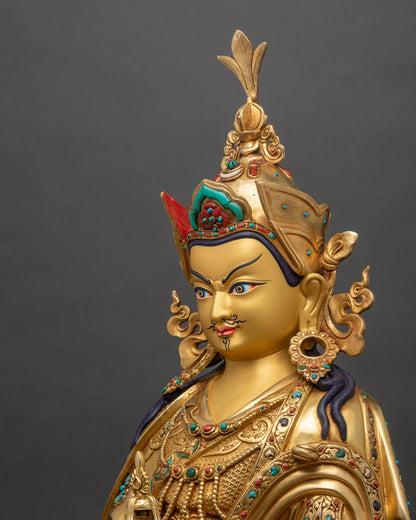 Guru Padmasambhava side view showing gold fire-gilded copper and khatvanga staff