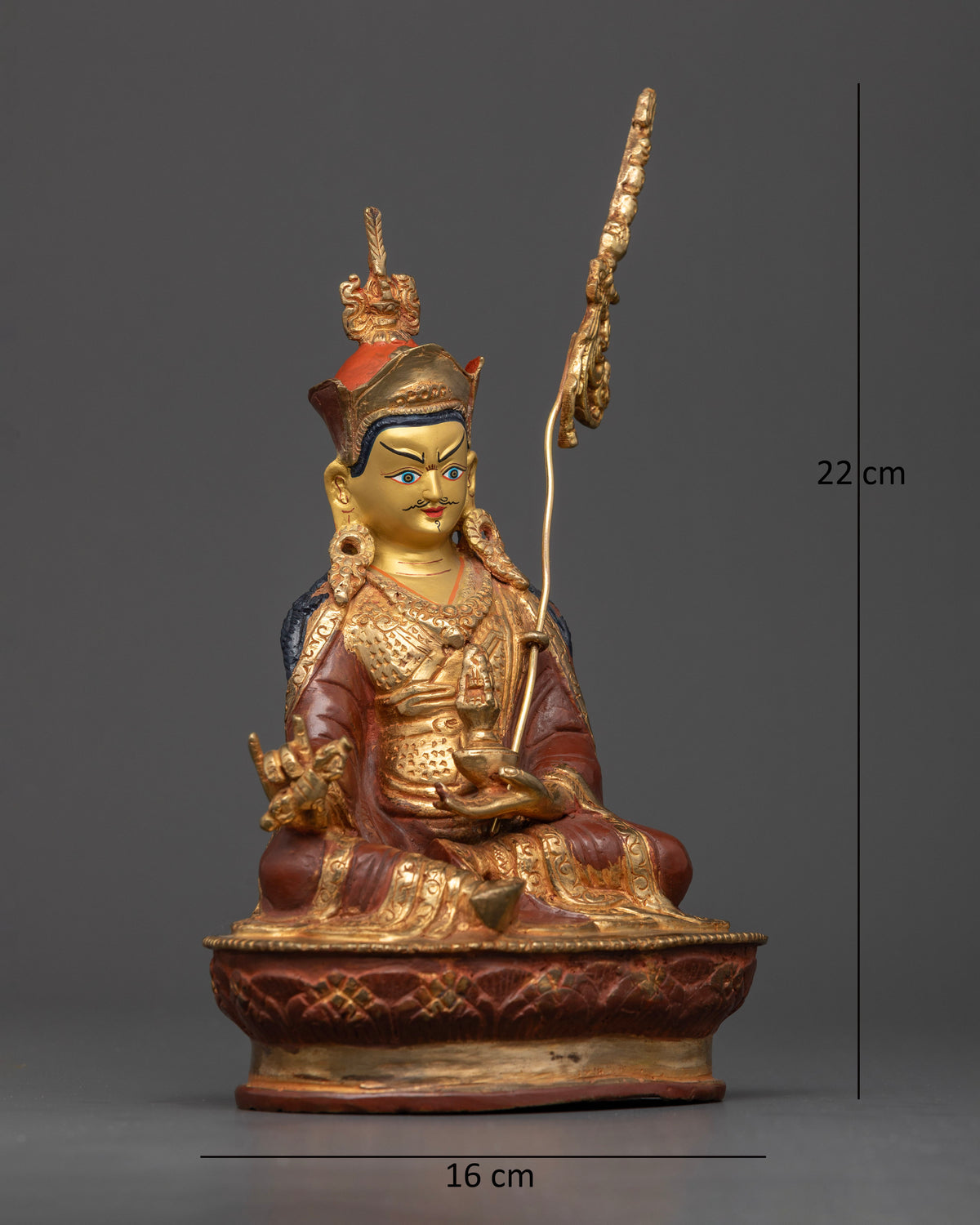 Guru Padmasambhava Statue with vajra skull cup and red lotus hat.