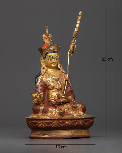 Guru Padmasambhava Statue with vajra skull cup and red lotus hat.