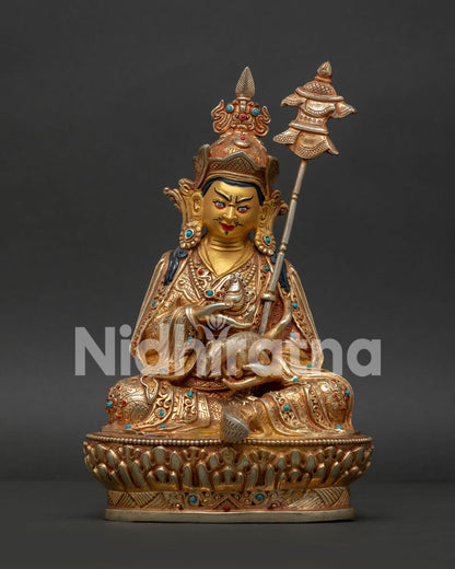 Guru Rinpoche copper statue with gold painted face turquoise coral stones and lotus pedestal.
