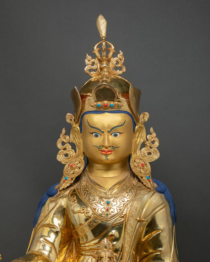 Guru Rinpoche Padmasambhava close up face detail with gold painted facial features and jeweled crown