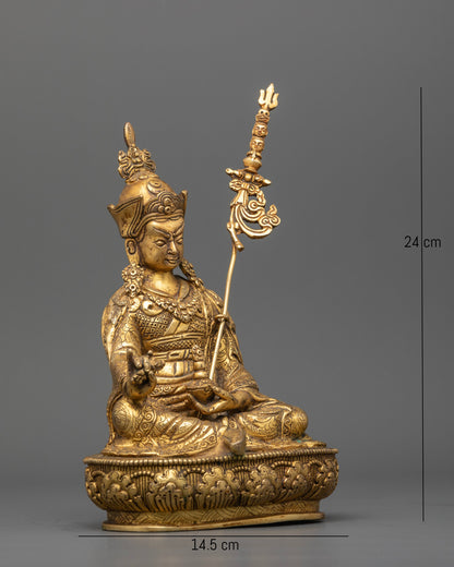 Guru Rinpoche Padmasambhava statue holding vajra and sacred skull cup.