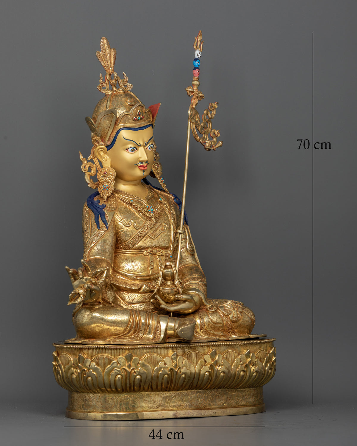 Guru Rinpoche Padmasambhava statue seated on a lotus pedestal with ornate crown and semi-precious stones