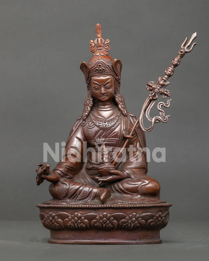 Guru Rinpoche seated on lotus pedestal with vajra kapala and khatvanga staff.